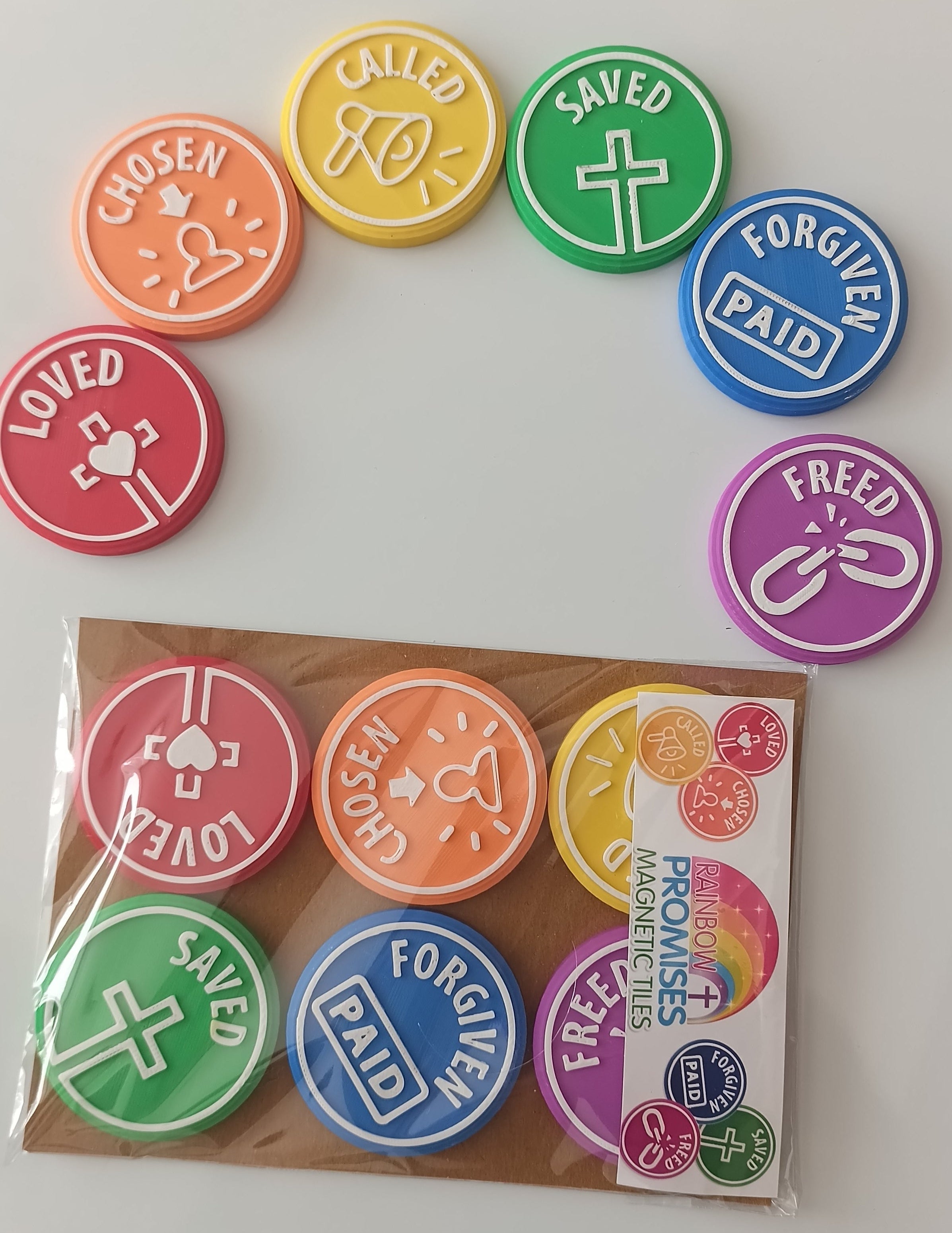 A set of colorful round Bible-themed magnets with white text and symbols, shown next to their retail packaging on a plain white background.
